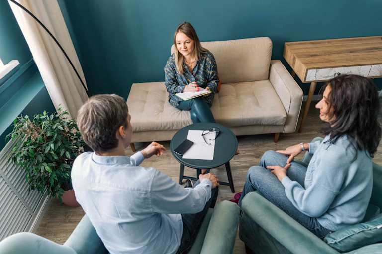 Psychologist speaking to couple during session