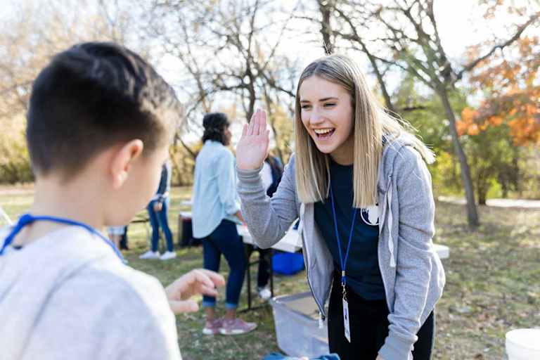 Social worker playing outside with child