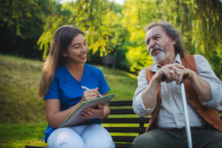 Rehabilitation counselor speaking to patient outside
