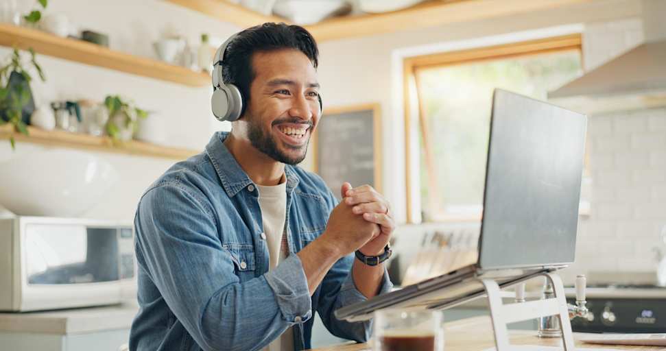 Man attending webinar on laptop at home