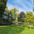 A pair of student sitting on the quadrangle lawn outside the residence halls on the University of Chicago campus.