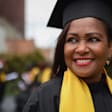Black female doctoral student smiling on her graduation day.