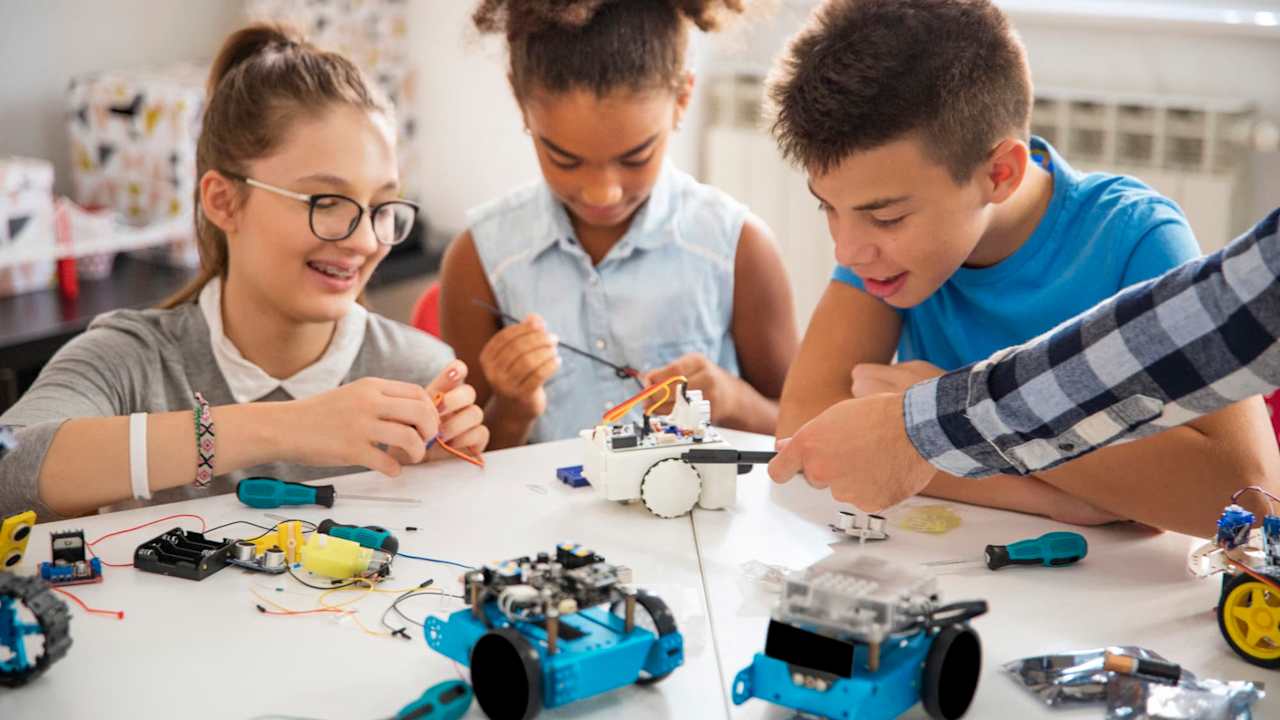 Happy kids building robotic cars