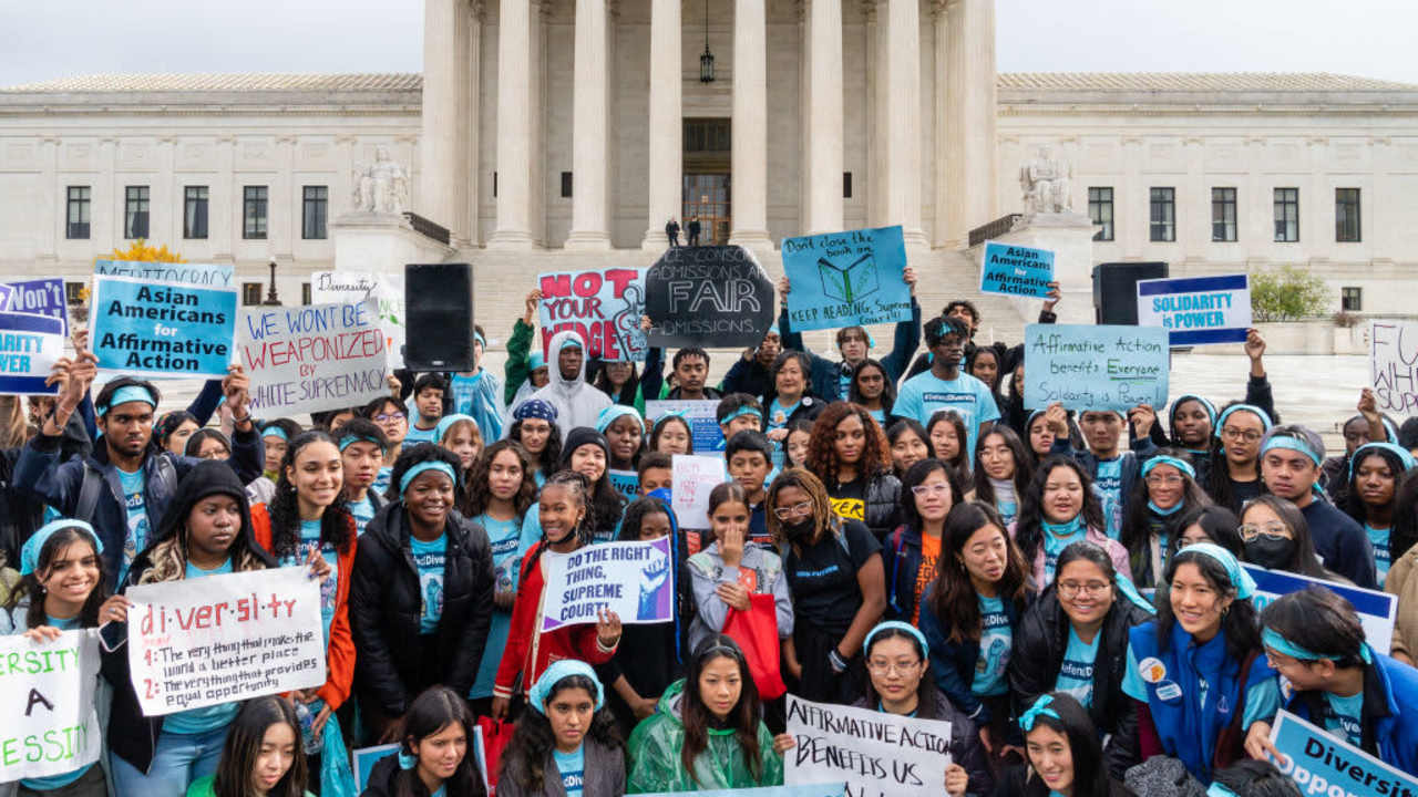 WASHINGTON, D.C. - OCTOBER 31: Supporters pose for a group photo during a rally in support affirmative action policies outside the Supreme Court in Washington, D.C. on October 31, 2022. The Supreme Court is again examining whether universities may consider race when trying to build diverse student bodies, reviewing admissions policies at Harvard University and the University of North Carolina. (Eric Lee for The Washington Post via Getty Images)