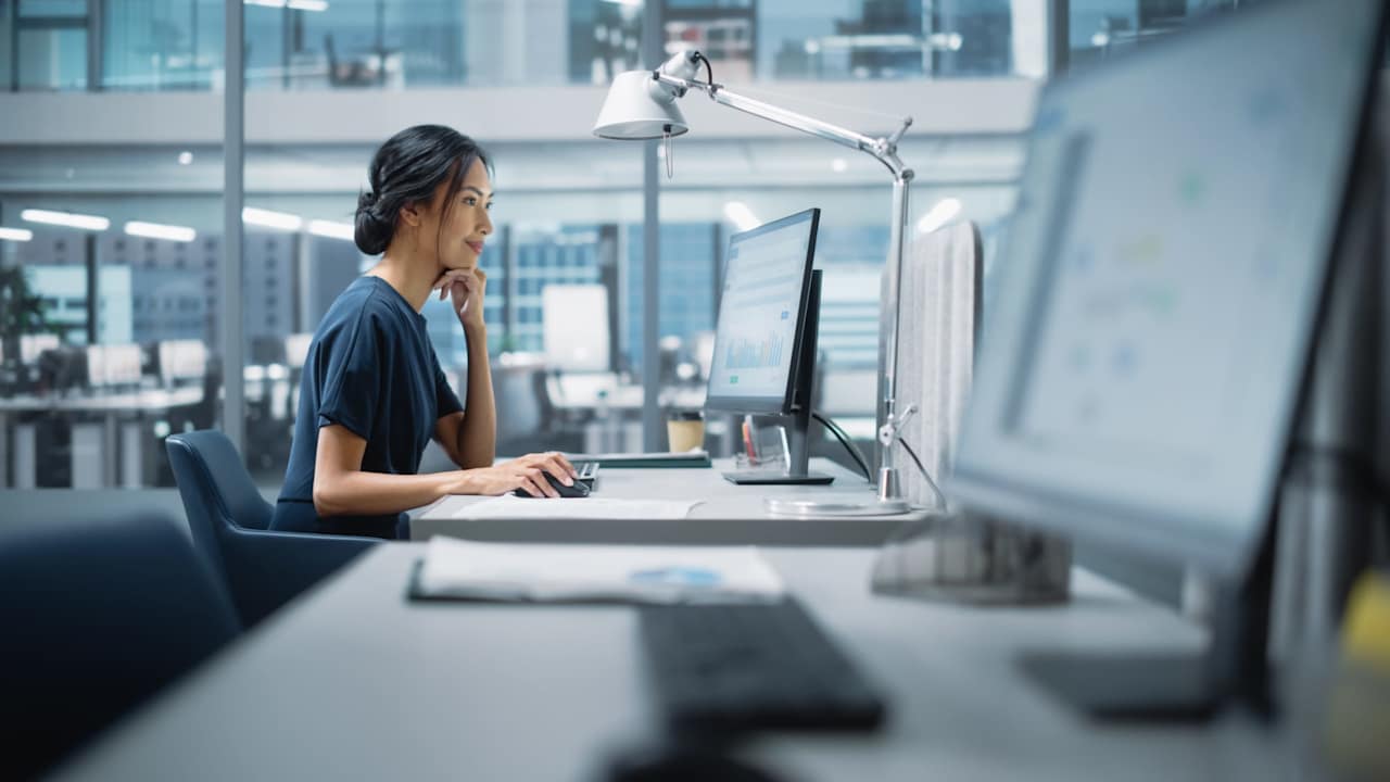 Woman using desktop computer in office