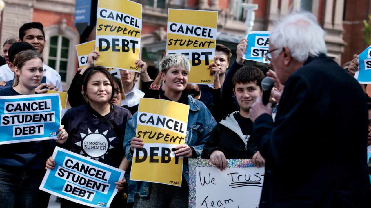 WASHINGTON, DC - APRIL 27: Activists listen as Sen. Bernie Sanders (I-VT) speaks at a Student Loan Forgiveness rally on Pennsylvania Avenue and 17th street near the White House on April 27, 2022 in Washington, DC. Student loan activists including college students held the rally to celebrate U.S. President Joe Biden's extension of the pause on student loans and also urge him to sign an executive order that would fully cancel all student debt. (Photo by Anna Moneymaker/Getty Images)