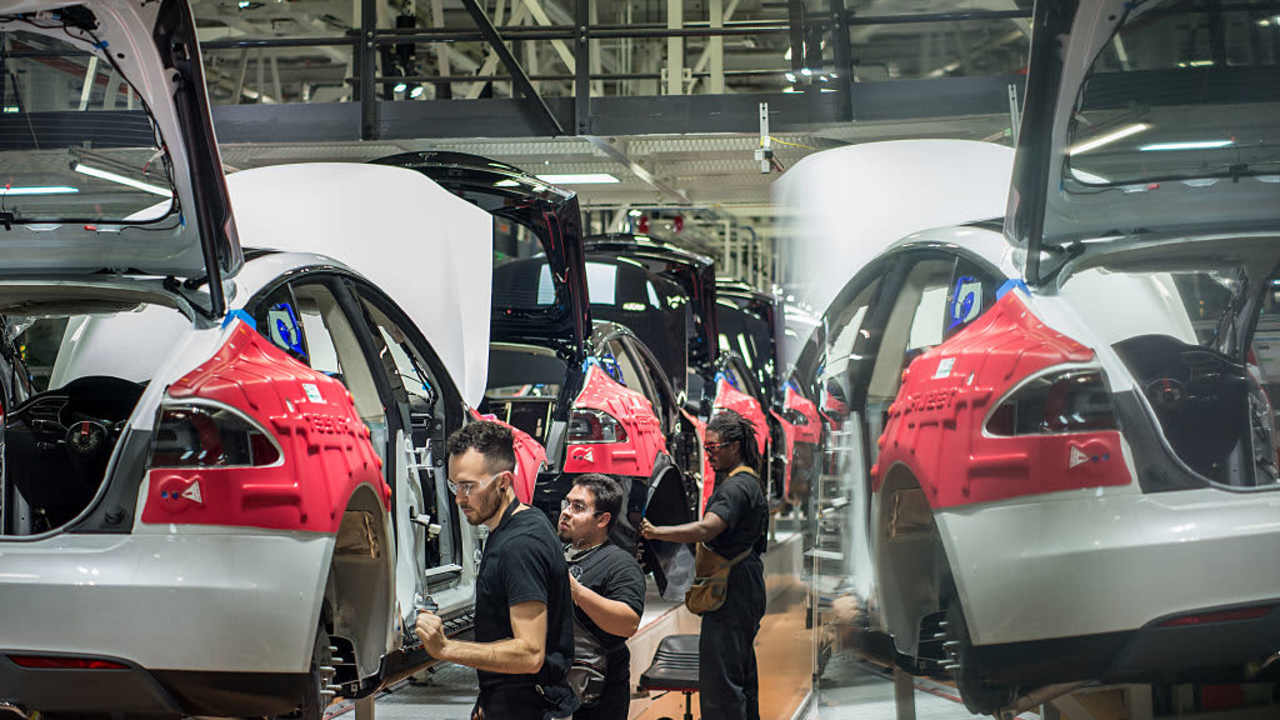 Workers assemble cars on the line at Tesla's factory in Fremont, California.