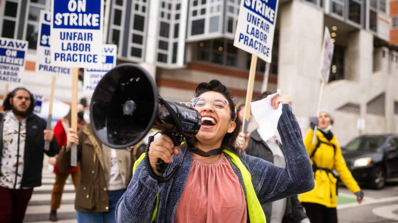 Los Angeles, CA - December 01:Gloria Bartolo, a 2nd year molecular biology PhD student, leads marching UCLA postdoctoral scholars and academic researchers in Westwood as they demand better wages, student housing, child care and more with University of California on Thursday, December 1, 2022 as contract negotiations continue and thousands strike. (Photo by Sarah Reingewirtz/MediaNews Group/Los Angeles Daily News via Getty Images)