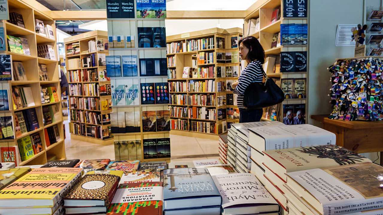 A woman looking at books in the Seminary Co-op Bookstores at University of Chicago. (Photo by: Jeffrey Greenberg/Universal Images Group via Getty Images)
