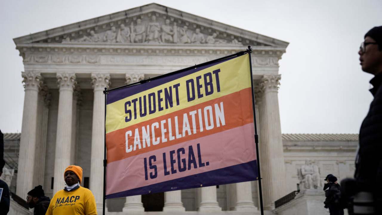 People rally in support of the Biden administration's student debt relief plan in front of the U.S. Supreme Court on February 28, 2023 in Washington, DC. Students are carrying signs that read, "Student debt cancellation in legal."