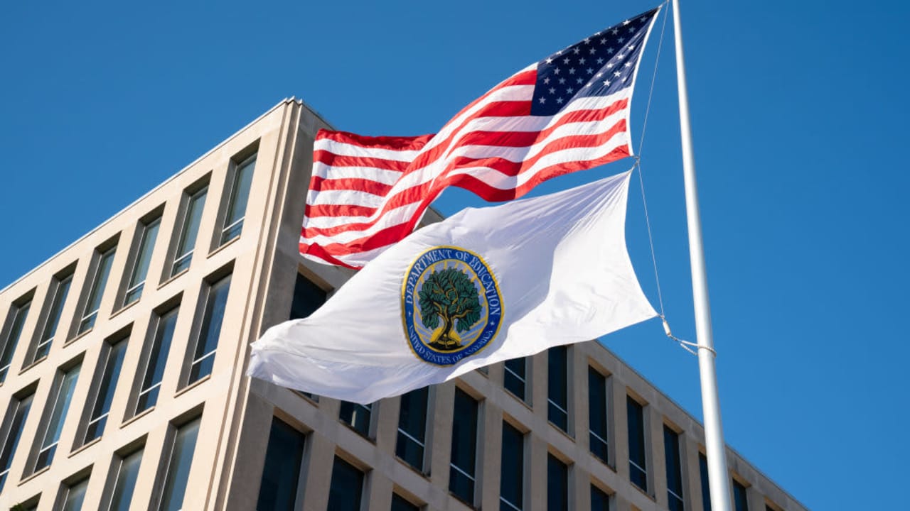 Flags for the U.S. and the U.S. Department of Education fly outside the Department of Education building in Washington, D.C.