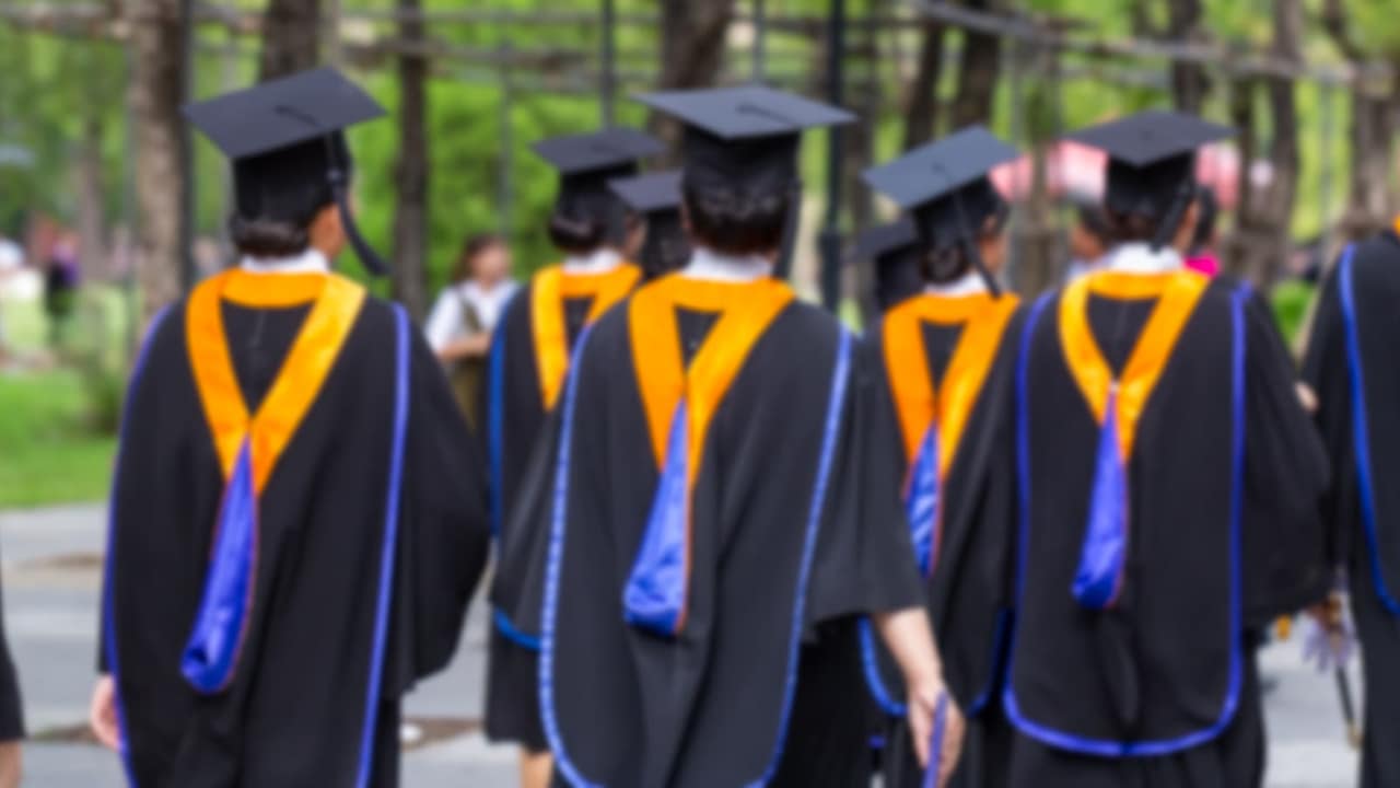 Blurred image back side view a group higher education graduation of graduates during commencement. Congratulation in University concept, Education concept.