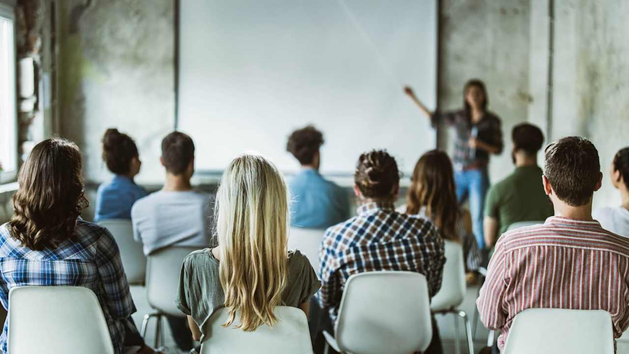 Students in a classroom listening to an instructor