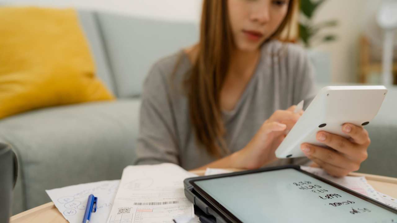 Woman analyzing documents while sitting at home.