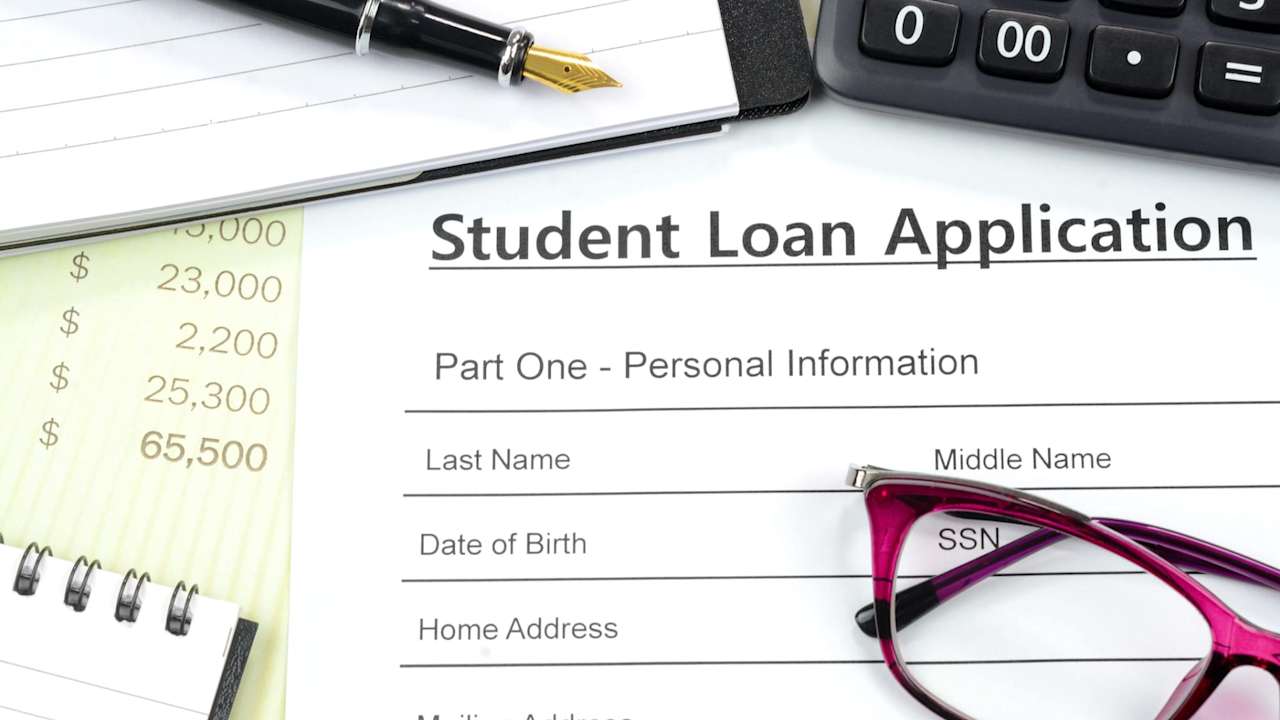 Student loan application on cluttered desk