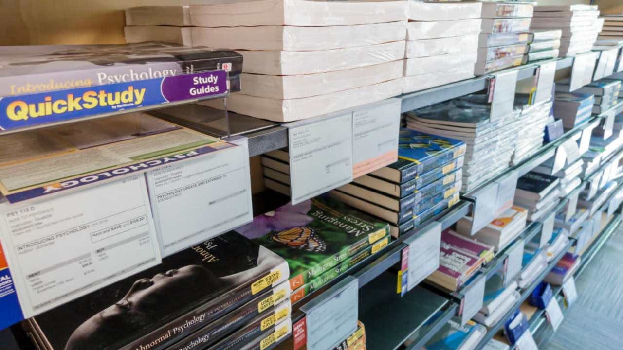 Stacks of college textbooks for sale in bookstore