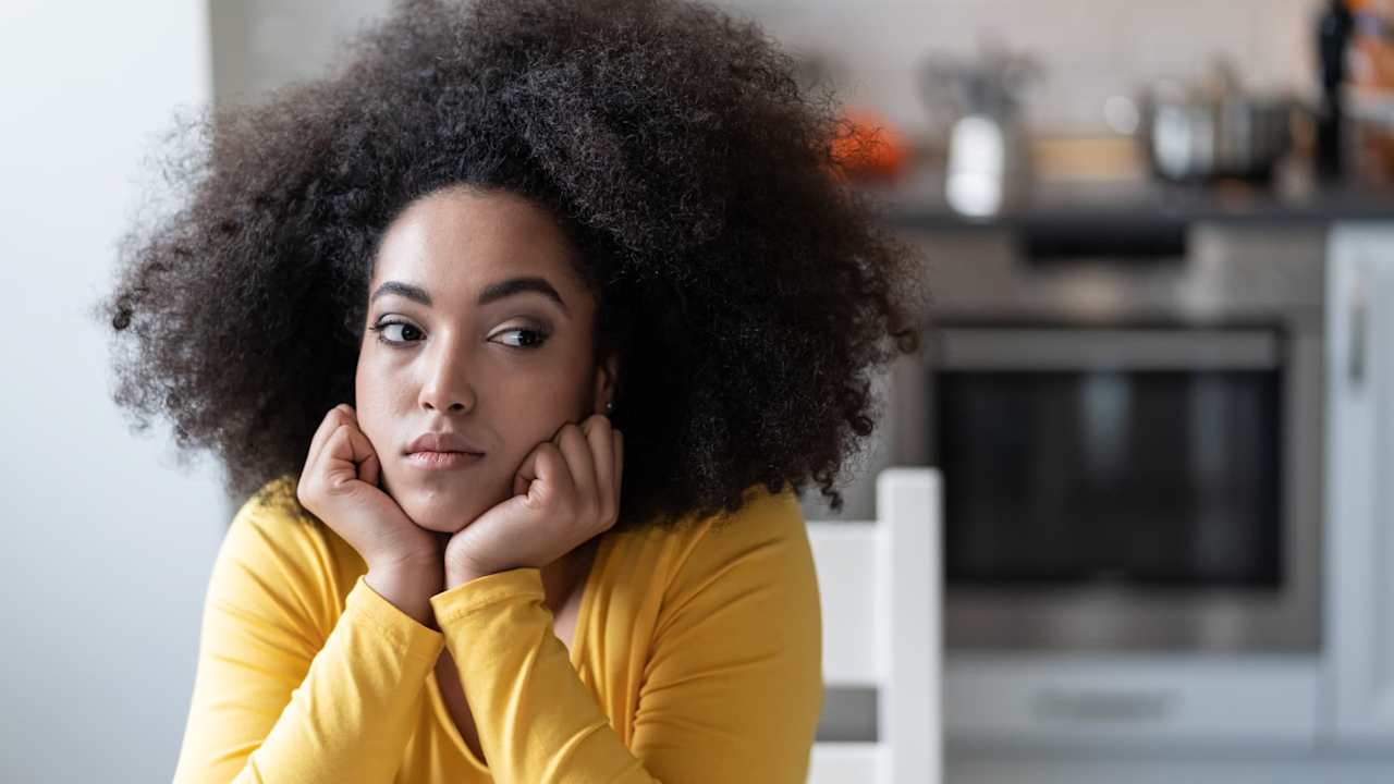Depressed young woman at home