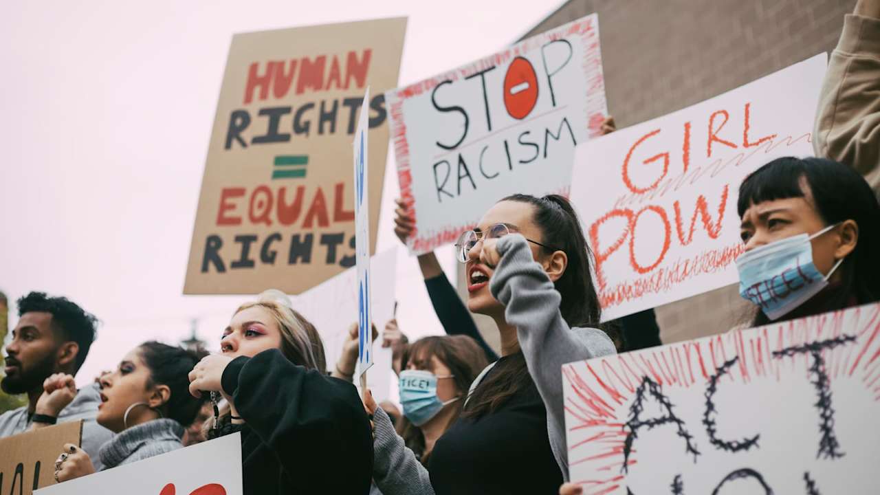 Male and female activists protesting for human rights in social movement