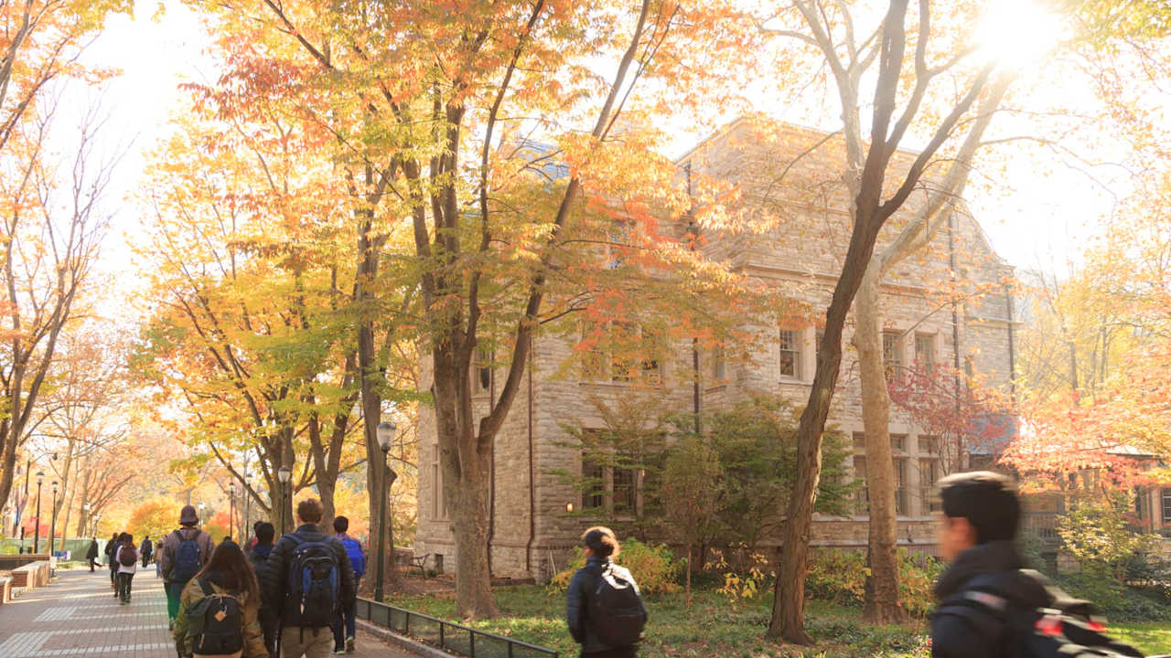 Students walking in autumn on University of Pennsylvania campus