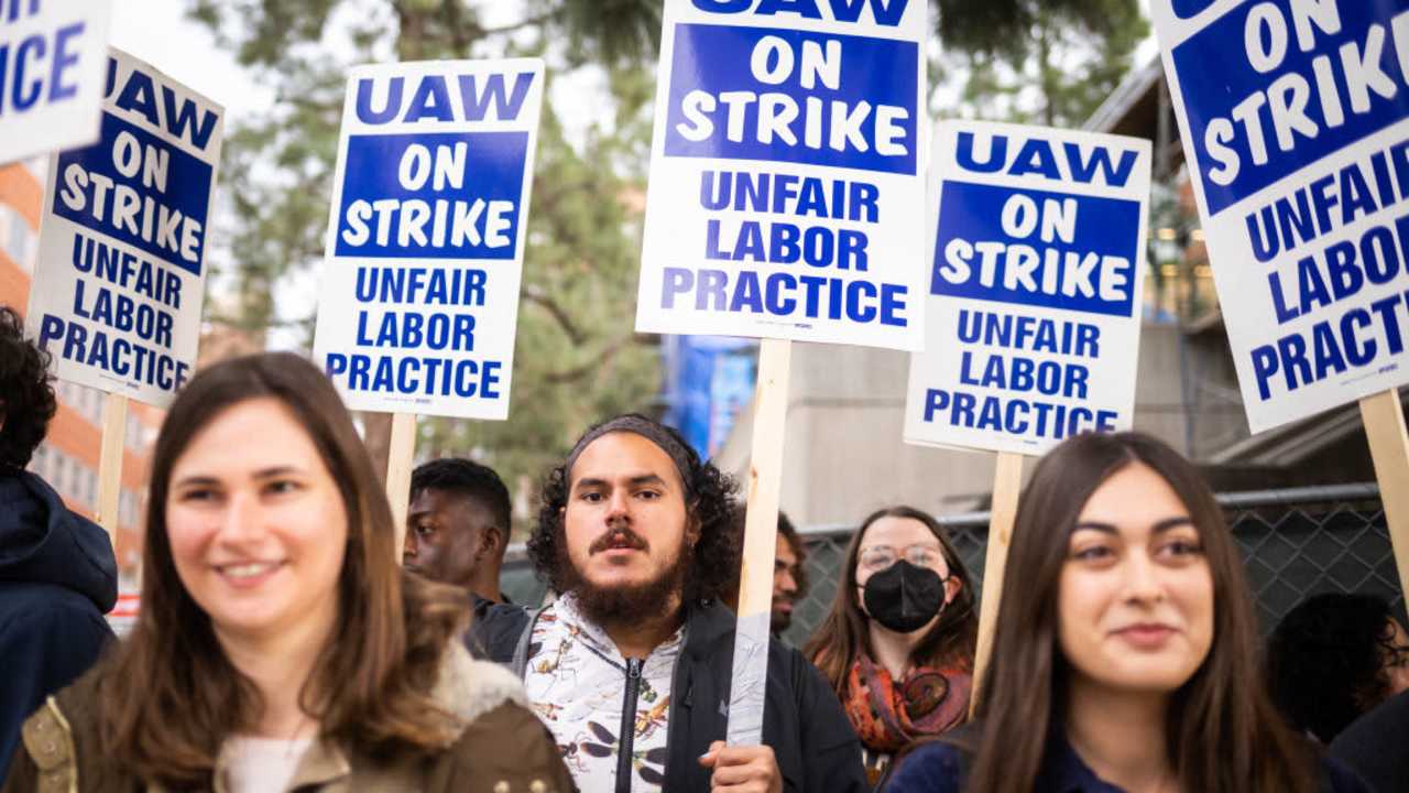 UCLA postdoctoral scholars and academic researchers march in Westwood to demand better wages, student housing, child care and more with University of California on Thursday, December 1, 2022 as contract negotiations continue and thousands strike.