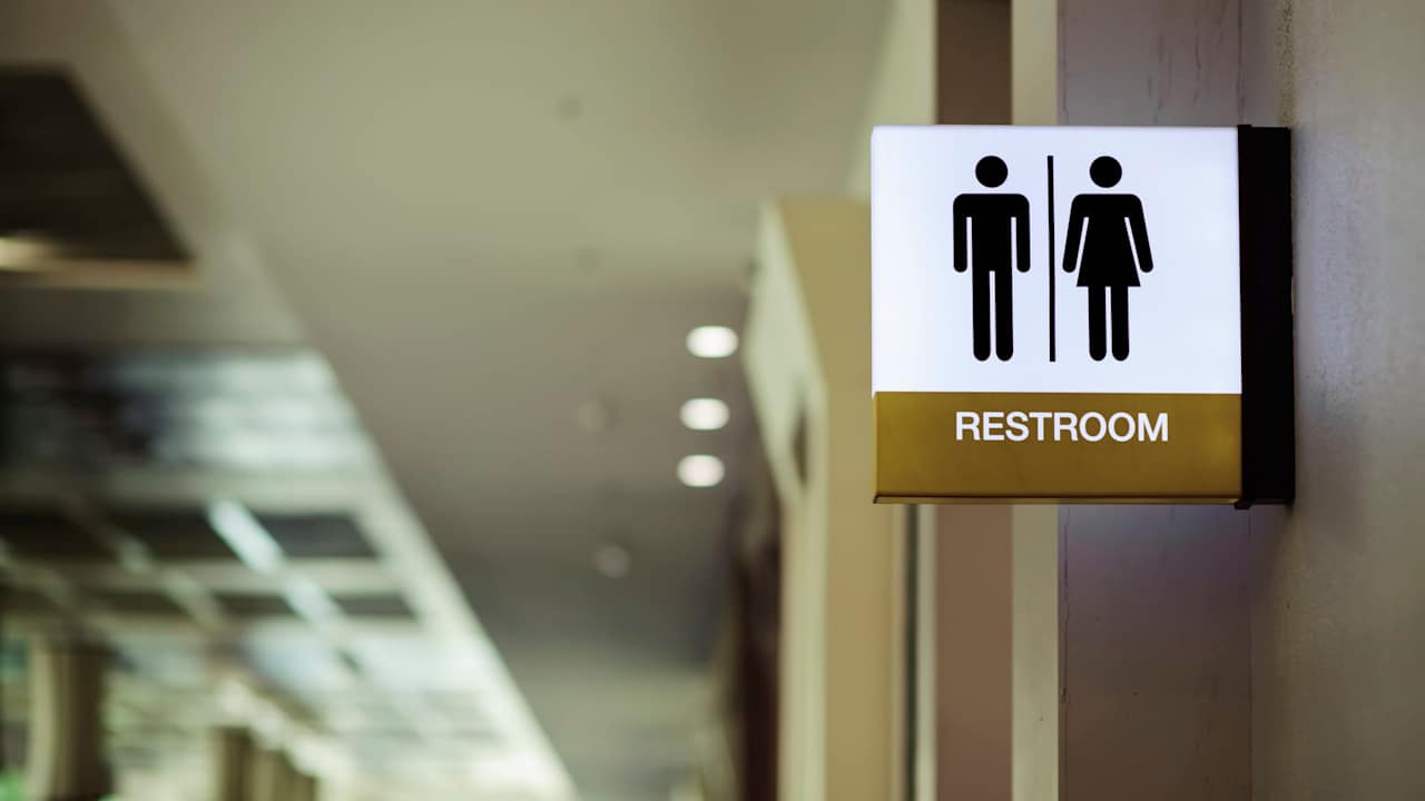 Sign at the entrance of a public restroom in a school building.