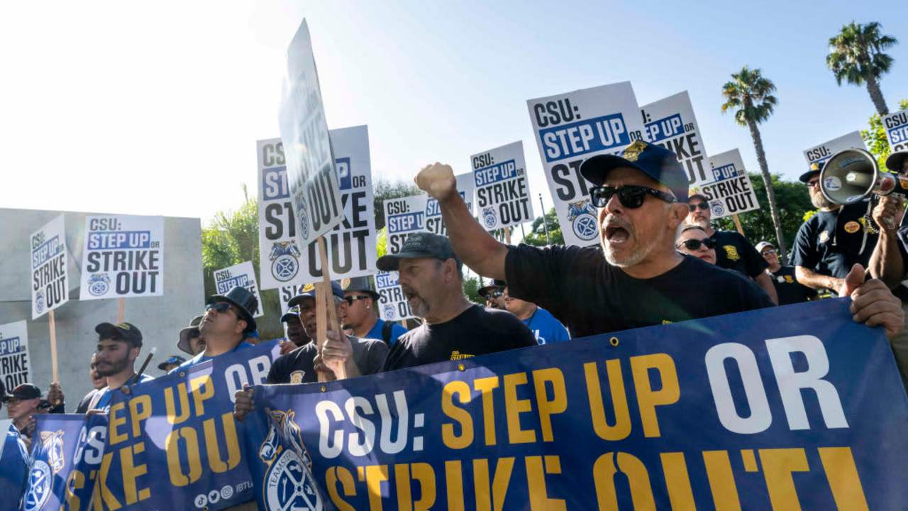 Protestors holding signs that read "CSU: Step Up Or Strike Out"