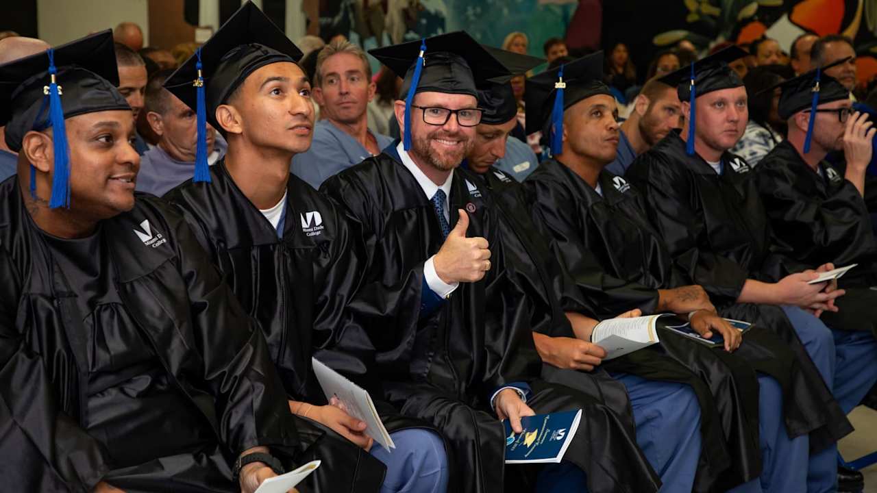 Larry "Eddie" Fordham smiling for the camera at his graduation ceremony at the Everglades Correctional Institution.