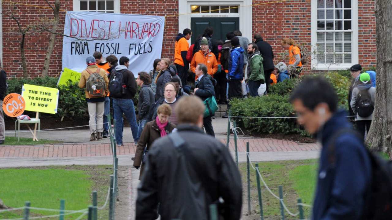 Protestors block the main entrance to the Harvard University President's office, calling for an open meeting with Harvard's governing body about fossil fuel divestment.