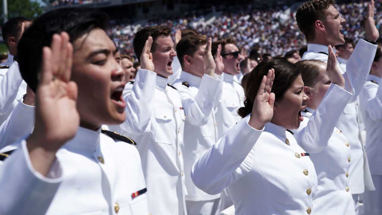 Naval Academy graduates reciting oath at ceremony
