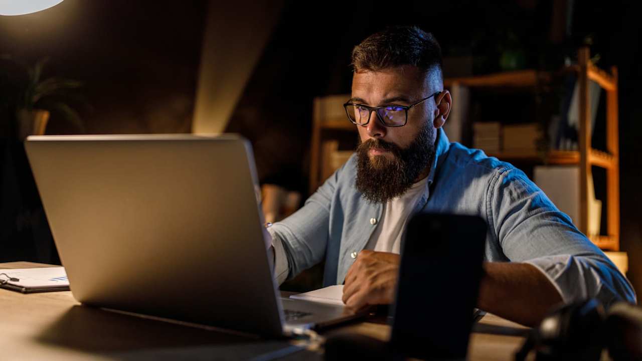 Online student typing on laptop
