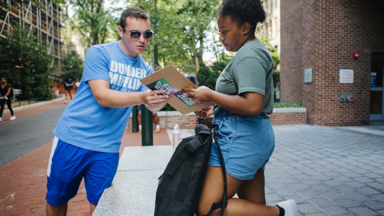 Coby Rich, a junior at the University of Pennsylvania, helps Makayla Davis, a 2nd year masters student, register to vote in Pennsylvania during a voter drive on campus in Philadelphia, Pennsylvania on August 31, 2022. The voter drive was for All in PA, a campaign from Pennsylvania Dems to register new voters in Pennsylvania.