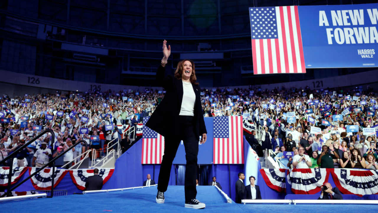 Democratic presidential nominee Kamala Harris excitedly waves at the crowd as she arrives for a campaign rally at the Bojangles Arena on September 12, 2024 in Charlotte, North Carolina.