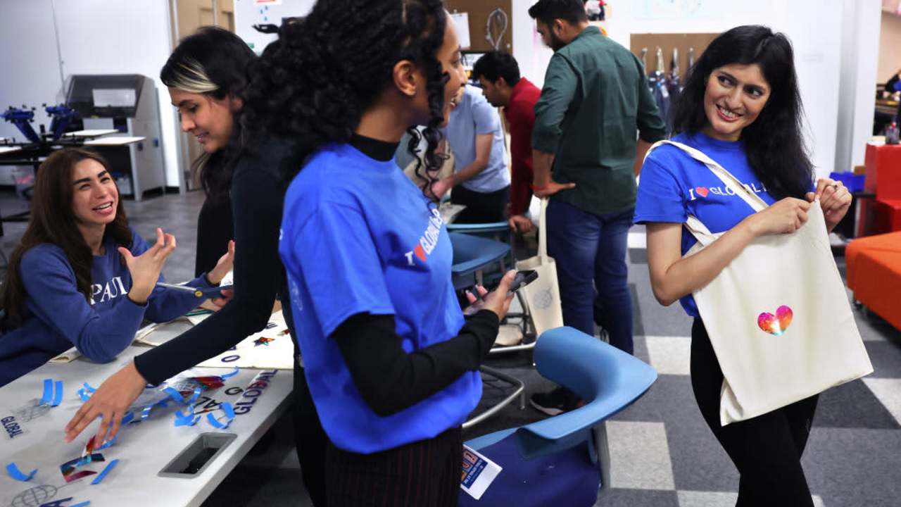 DePaul University students Beemnet Desta of Ethiopia and Suchita Farkiwala of India talk after making tote bags at a social gathering for international students at the school's downtown Chicago campus.