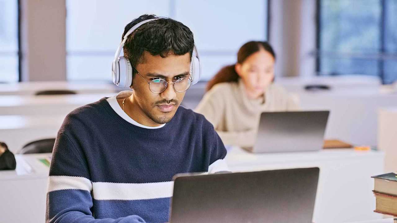 Student in headphones and laptop for classroom education