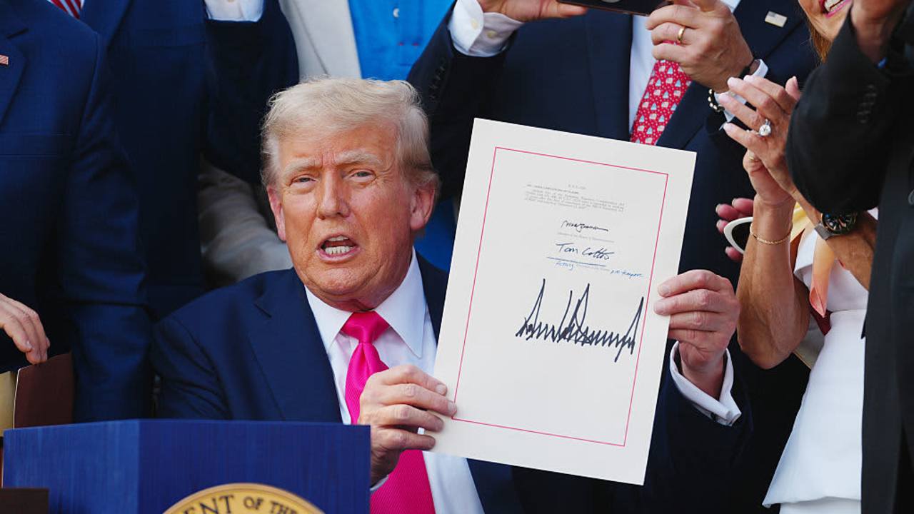 S President Donald Trump displays the signed bill during a ceremony for the One Big Beautiful Bill Act on the South Lawn of the White House in Washington, DC, US, on Friday, July 4, 2025. Trump signed his $3.4 trillion budget bill into law Friday, enshrining an extension of tax cuts, temporary new breaks for tipped workers and funding to crack down on illegal immigration.