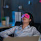 Young female work hard and sleep while working late
