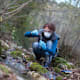 Woman Biological Researcher Taking a Plant Sample from Water