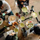 College roommates enjoying breakfast while talking with each other.