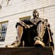The John Harvard statue on the Harvard University campus in Cambridge. Massachusetts.