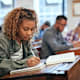 Cropped shot of university students sitting in class taking exam