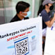 WEST HOLLYWOOD, CALIFORNIA - AUGUST 03: Health workers sit at a check-in table at a pop-up monkeypox vaccination clinic which opened today by the Los Angeles County Department of Public Health at the West Hollywood Library on August 3, 2022 in West Hollywood, California. California Governor Gavin Newsom declared a state of emergency on August 1st over the monkeypox outbreak which continues to grow globally.