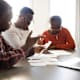 A senior father with his adult son and daughter discusses a way to find enough money to pay all bills.
