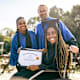 Teacher and student showing diploma at graduation
