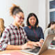 Young women learning computer programming