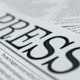 A close up picture of the word "Press" written atop a newspaper page.