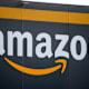 The logo for Amazon.com Inc. at the company's fulfillment center in Bretigny-sur-Orge, France, on Wednesday, Nov. 25, 2022. Amazon employees in the US, UK, India, Japan, Australia, South Africa and across Europe are demanding better wages and working conditions as the cost-of-living crisis deepens, in a campaign dubbed "Make Amazon Pay." Photographer: Benjamin Girette/Bloomberg via Getty Images