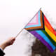 Boston, MA - March 31: A person waves a Pride flag during a Transgender Day of Visibility Event named, We Are A State of Love: A Gathering of Visible Solidarity With LGBTQ Youth outside of the State House in Boston on March 31, 2022. (Photo by Jessica Rinaldi/The Boston Globe via Getty Images)