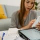 Woman analyzing documents while sitting at home.