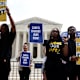 Activists holding signs that read "cancel student debt" outside of the US Supreme Court Building