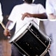 A group of HBCU marching band drummers practice playing before a big competition.